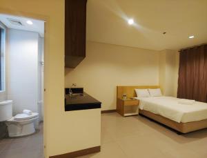 Ένα ή περισσότερα κρεβάτια σε δωμάτιο στο Kaizen Suites