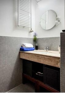 a bathroom with a sink and a mirror at Kent Ridge Loft in Prague