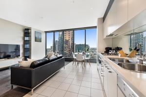 a kitchen with a view of a city at Luxury designer suite in most prestigious location in Melbourne in Melbourne
