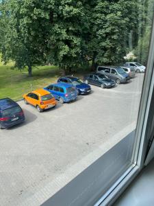 a group of cars parked in a parking lot at Hotel DANIELA in Nīca