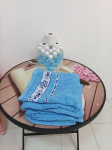 a table with a stack of towels and bottles of water at Ike village in Kota Samarahan