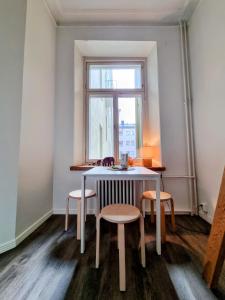 a table and chairs in a room with a window at 4 Blocks From Stockmann in Helsinki