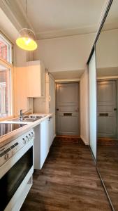 a kitchen with a sink and a stove at 4 Blocks From Stockmann in Helsinki