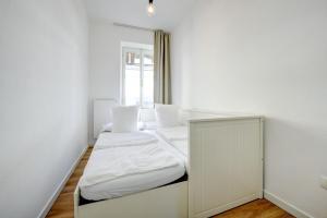 a white room with two beds and a mirror at BELLAVISTA - Garda Leisure in Salò