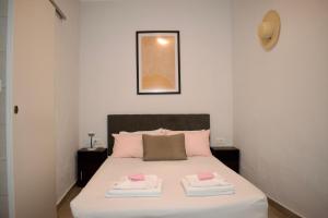 um quarto com uma cama com duas toalhas em Astrinos Apartment, cosy and near to the beach! em Kato Daratso