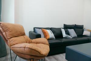 a living room with a couch and a chair at Kozy Stay in Taitung City