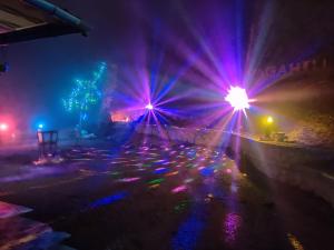 a lit up street at night with purple and blue lights at Vaga Hills Resort in Vagamon