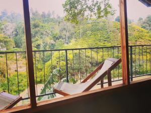 a room with a balcony with a view of a mountain at Ayubo Ella - Bed & Breakfast in Ella