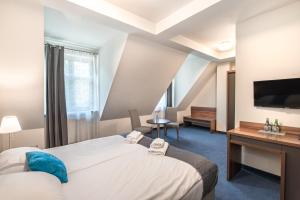 Łóżko lub łóżka w pokoju w obiekcie Apartamenty Rynek 20