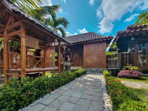 a house with a pathway in front of it at Dem Ayem Heritage Guest House in Yogyakarta