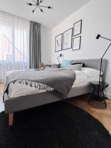 a white bedroom with a large bed and a window at Pension MONO - Adults Only in Český Krumlov