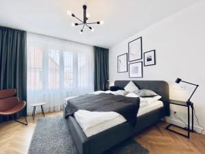 a bedroom with a large bed and a window at Pension MONO - Adults Only in Český Krumlov