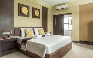 a bedroom with a large bed in a room at The Wing Design Hotel in Bangkok