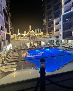 a swimming pool in a building at night at Metamorfoz Apartment in Mamaia Nord