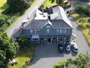 an aerial view of a large blue house with cars parked at The Elan Valley Hotel in Rhayader