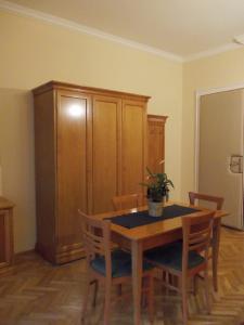 a dining room with a table and chairs and a cabinet at Flatneartocastlehill in Budapest