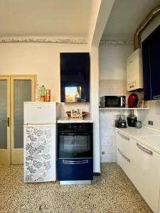 a kitchen with a blue and white stove top oven at Venice -Mestre Rooms in Mestre