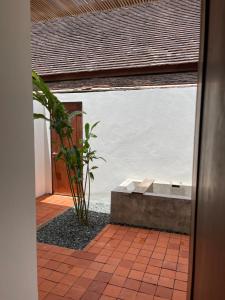 a bathroom with a large window with a bath tub at Le Sen Boutique Hotel in Luang Prabang