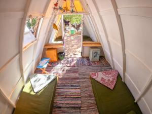 an interior view of a tiny house with green chairs at Elrayga Camp Dahab in Dahab