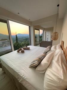 a bedroom with a bed with a view of a giraffe at Corfu Gaia View Studio in Episkopianá