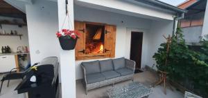 a living room with a couch and a window at Didova kuća in Brodarica