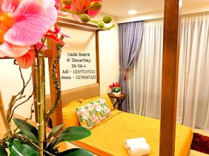 a room with a bed and a sign on the wall at TimurBay Seafront Residence at Casa Inara in Kuantan