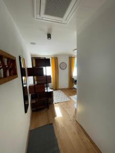 a living room with white walls and wooden floors at Mini-Apartment Admont in Admont