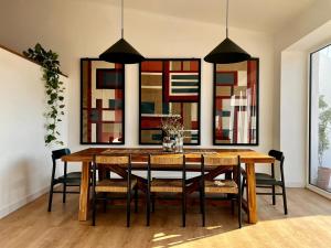 a dining room with a wooden table and chairs at Viva! Farmhouse in Monsaraz