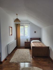 sypialnia z 2 łóżkami i oknem w obiekcie Pensiunea Iris w mieście Syhot Marmaroski
