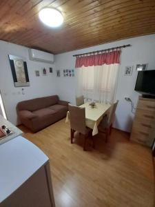 a living room with a table and a couch at Countryside apartments Doris in Višnjan