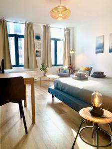 a bedroom with a large bed and a living room at Bright and Cozy in Antwerp Central Station in Antwerp