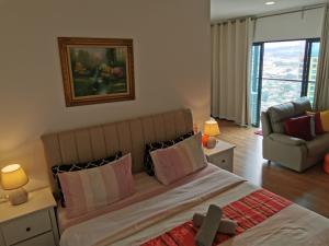 a bedroom with a large bed and a couch at Apple 4@Menara Simfoni/King Bed/Wifi/Netflix/TVBOX in Cheras