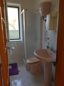 a bathroom with a toilet and a sink at Villetta nel Verde in Ascea