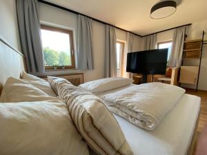 a bedroom with two white pillows on a bed at Waldruh in Wiesing