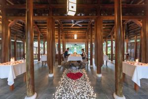 a restaurant with two people sitting at a table with a heart on it at Pilgrimage Village Boutique Resort & Spa in Hue