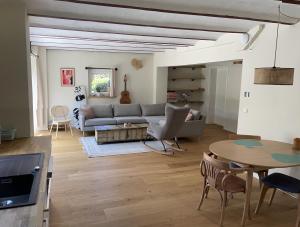 a living room with a couch and a table at Ferienwohnung Haus am Uckersee in Prenzlau +15 photos