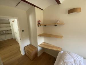 a room with a stairway with wooden shelves on the wall at Ferienwohnung Haus am Uckersee in Prenzlau