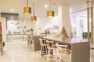 a kitchen with a large island with bar stools at POP! Hotel Kelapa Gading in Jakarta