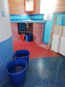 a room with three blue buckets on the floor at Hôtel Safari Vezo Anakao in Anakao