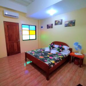 a bedroom with a bed in a room at Pamujo Hostel in Baclayon