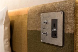 an electrical outlet on the side of a couch at Hotel Resol Nagoya in Nagoya