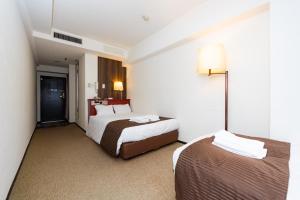 Postel nebo postele na pokoji v ubytování Sky Heart Hotel Koiwa