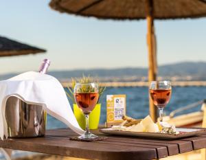 a table with two glasses of wine and cheese at Golden Star City Resort in Perea