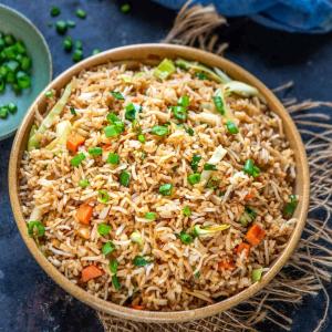 a bowl of fried rice on a table at Hotel Vamdev Fort in Pushkar