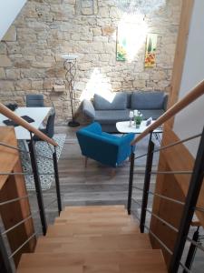 a staircase with a blue chair and a table in a room at Die Französin - Ingo Telschow & Catherine Tempier Gbr in Deidesheim