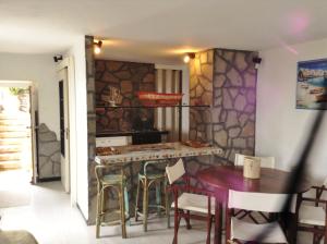 a kitchen with a counter and a table and chairs at Le case di Recco by Holiday World in Recco