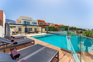 a villa with a swimming pool and a house at Chalet Golf Costa Adeje 3A003 in Adeje