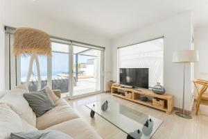 a living room with a white couch and a tv at Chalet Golf Costa Adeje 3A003 in Adeje