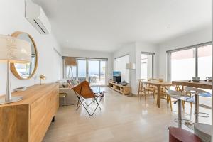 a living room with a table and a dining room at Chalet Golf Costa Adeje 3A003 in Adeje
