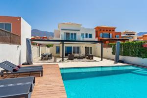 a villa with a swimming pool and a house at Chalet Golf Costa Adeje 3A003 in Adeje
